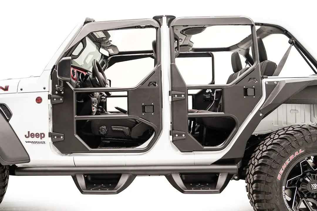 Fab Fours full tube doors on a lifted white Jeep Wrangler JL Rubicon Unlimited, front driver-side view, showing black tubular front and rear doors with steel lower panels, with a Fab Fours front bumper and grille