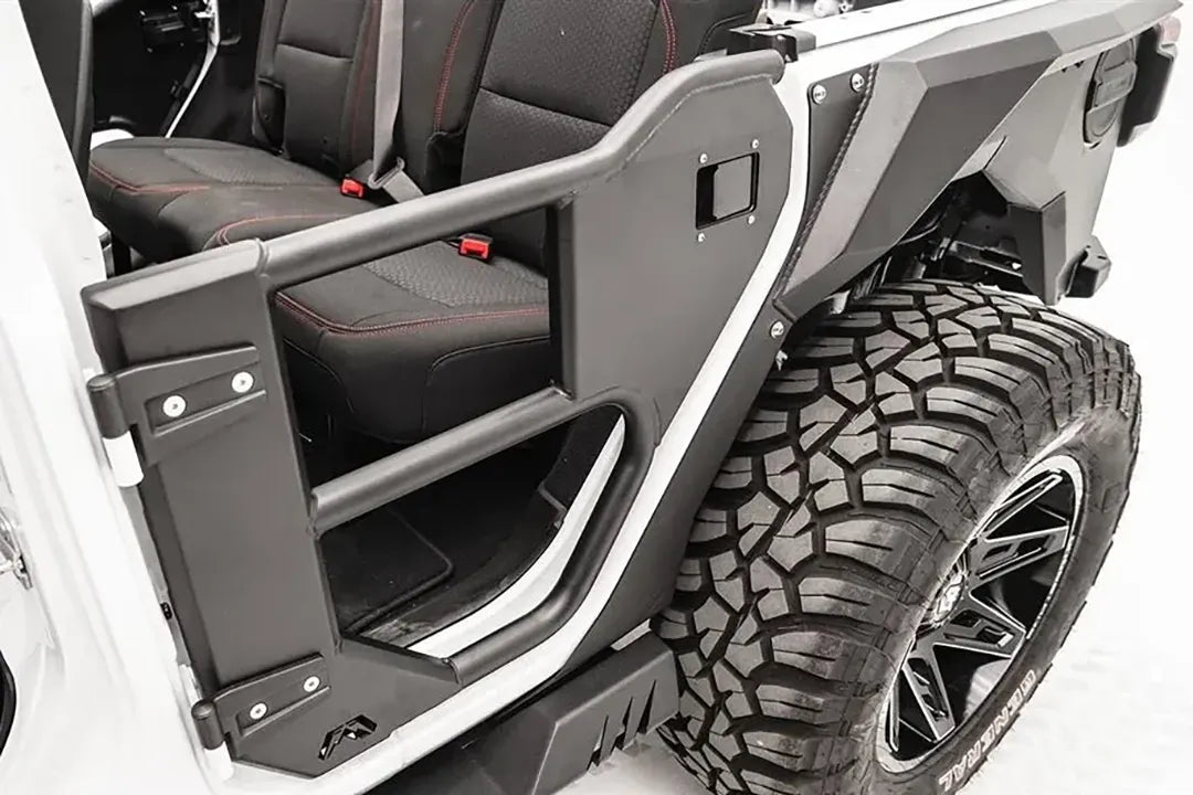 Fab Fours rear half tube door on a white Jeep Wrangler JL, close-up view, showing the tubular frame, steel lower panel, latch and hinge mounts