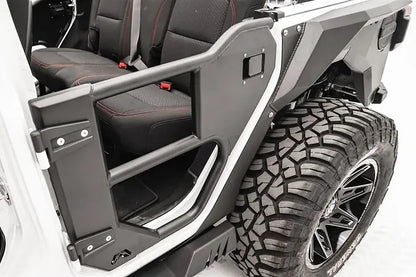 Fab Fours rear half tube door on a white Jeep Wrangler JL, close-up view, showing the tubular frame, steel lower panel, latch and hinge mounts