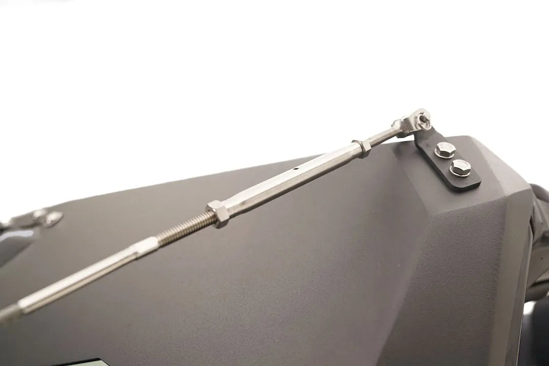 Close-up of the Fab Fours ViCowl Limb Riser turnbuckle, showing the stainless adjustable tensioner bolted to a bracket on the ViCowl