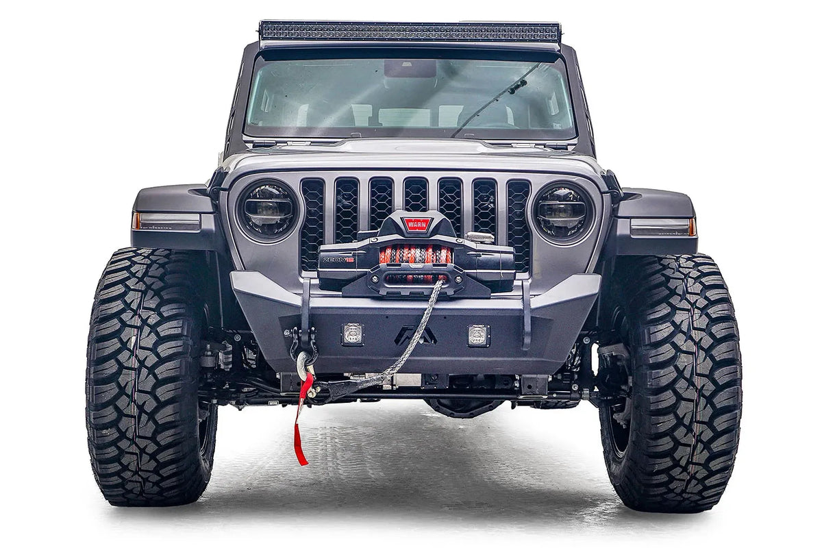 Fab Fours Stubby bumper on a gray Jeep Gladiator JT, straight-on front view, showing the low-profile bumper, centered winch and recessed light pods