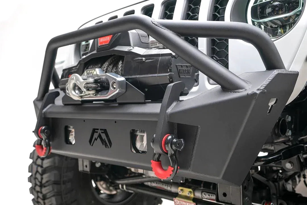 Fab Fours Stubby bumper with pre-runner guard, close-up of the front bumper, showing the tube hoop, winch fairlead, cube light cutouts and red D-ring shackles