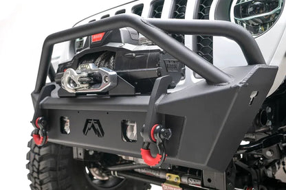 Fab Fours Stubby bumper with pre-runner guard, close-up of the front bumper, showing the tube hoop, winch fairlead, cube light cutouts and red D-ring shackles