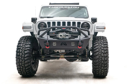 Fab Fours Stubby bumper with pre-runner guard on a white Jeep Wrangler JL, straight-on front view, showing the tube hoop, centered winch and red D-ring shackles