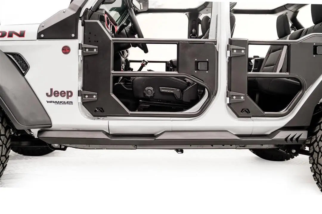 Fab Fours Light Rock Slider on a white Jeep Wrangler Unlimited, driver-side view, showing the low-profile flat rocker guard running beneath the tube doors
