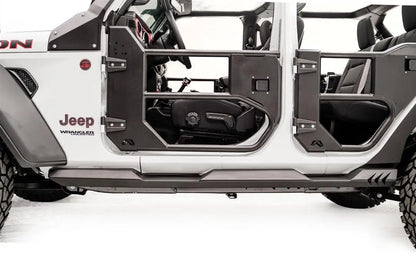Fab Fours Light Rock Slider on a white Jeep Wrangler Unlimited, driver-side view, showing the low-profile flat rocker guard running beneath the tube doors