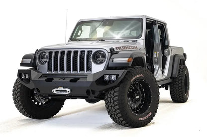 Fab Fours Matrix front bumper on a silver Jeep Gladiator JT, driver-side front three-quarter view, showing the full-width bumper, winch fairlead and cube light pods