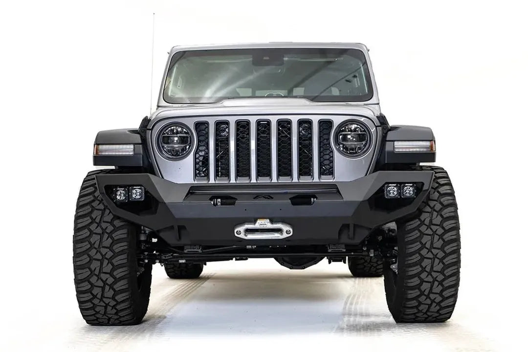 Fab Fours Matrix front bumper on a silver Jeep Gladiator JT, straight-on front view, showing the full-width bumper, centered winch fairlead and corner light pods