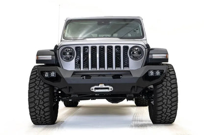 Fab Fours Matrix front bumper on a silver Jeep Gladiator JT, straight-on front view, showing the full-width bumper, centered winch fairlead and corner light pods