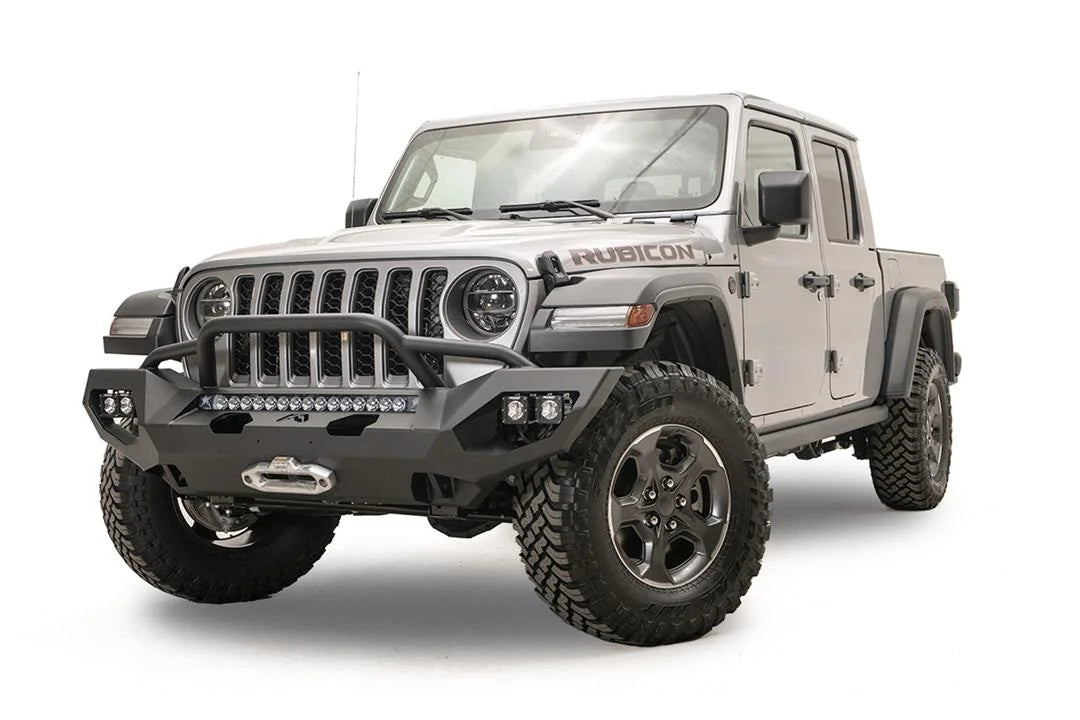 Fab Fours Matrix front bumper with pre-runner guard on a silver Jeep Gladiator JT, driver-side front three-quarter view, showing the tube hoop, LED light bar and winch fairlead