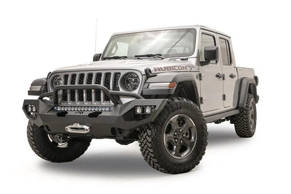 Fab Fours Matrix front bumper with pre-runner guard on a silver Jeep Gladiator JT, driver-side front three-quarter view, showing the tube hoop, LED light bar and winch fairlead
