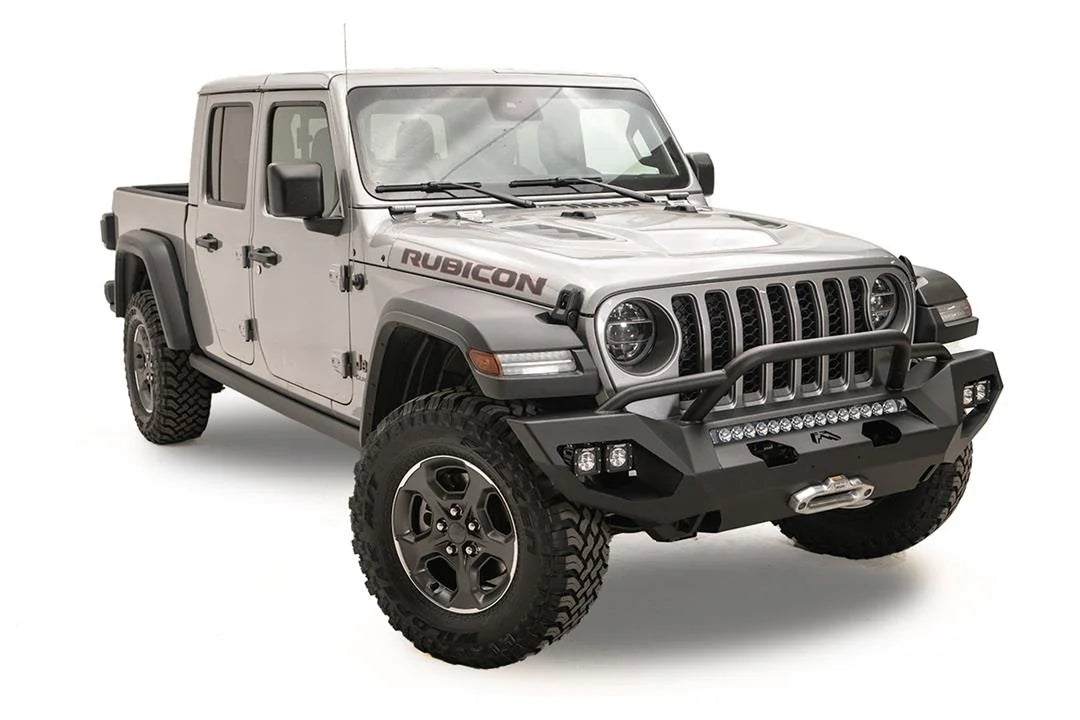 Fab Fours Matrix front bumper with pre-runner guard on a silver Jeep Gladiator JT, passenger-side front three-quarter view, showing the tube hoop, LED light bar and cube light pods