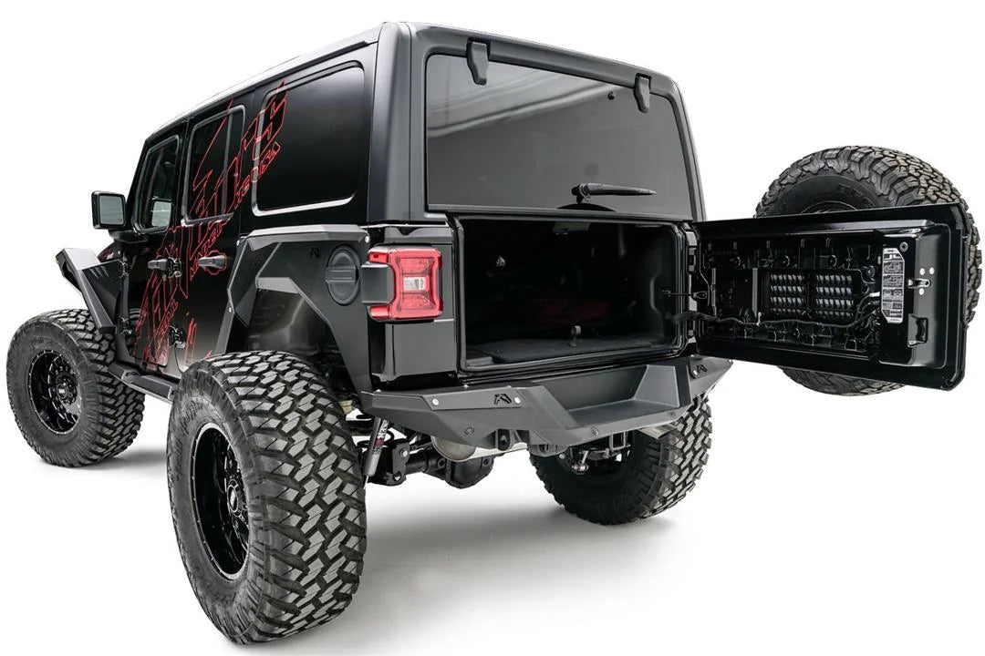 Fab Fours heavy-duty rear bumper on a lifted black Jeep Wrangler JL Unlimited with red graphics, driver-side rear three-quarter view, with tailgate open