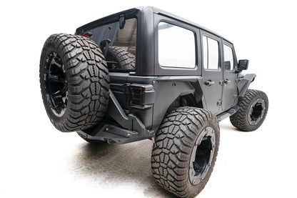Fab Fours Off-The-Door Tire Carrier on a gray Jeep Wrangler JL Unlimited, rear passenger-side view