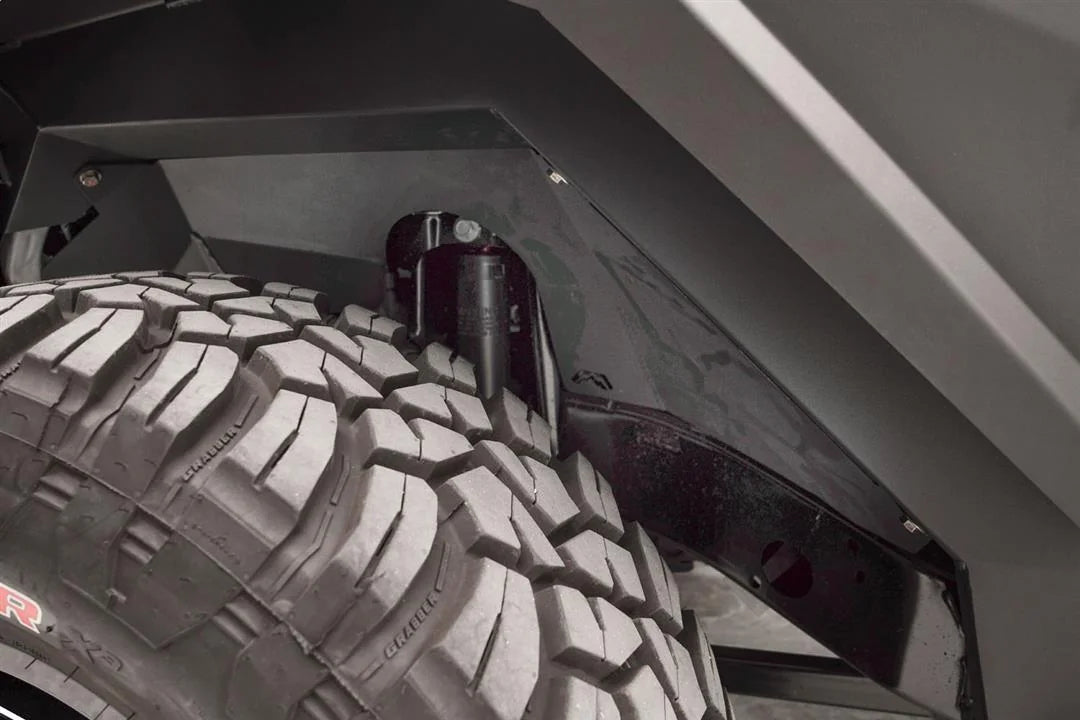Close-up of Fab Fours front inner fender liner with Fab Fours logo cutout around the shock tower of a Jeep Wrangler JL