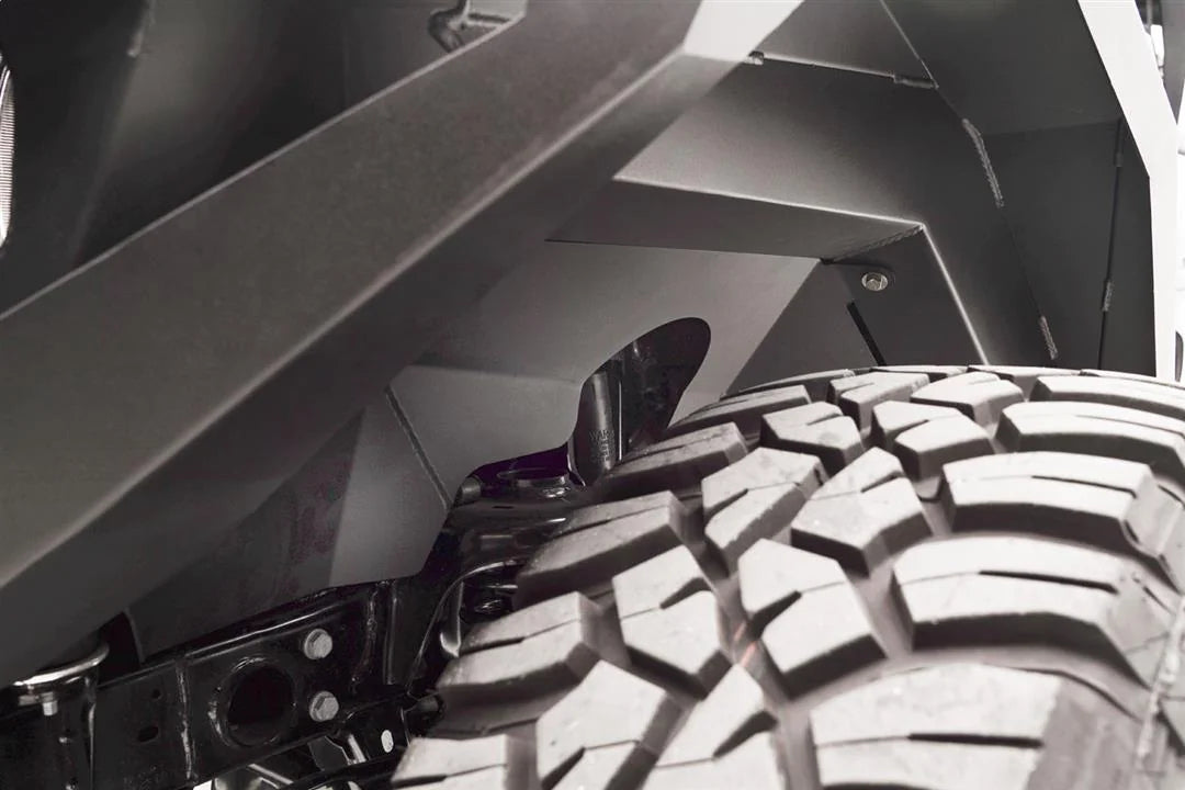 Close-up of Fab Fours front inner fender liner above the tire and shock on a Jeep Wrangler JL