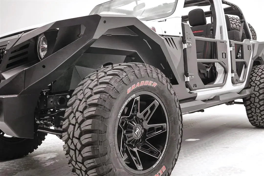 Fab Fours front inner fender and fender flare on a lifted white Jeep Wrangler JL with tube doors, driver-side front three-quarter view, with Fab Fours winch bumper