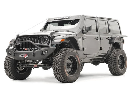 Fab Fours front and rear fender flares on a lifted gray Jeep Wrangler JL Unlimited, driver-side front three-quarter view, with Fab Fours front winch bumper and cowl armor