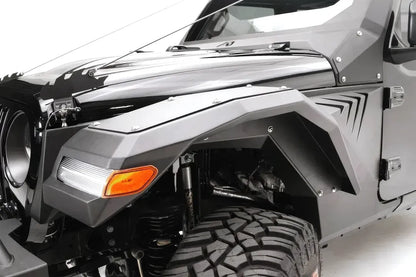 Fab Fours front fender flare with LED turn signal and gill vents on the driver side of a black Jeep Wrangler JL, angled close-up