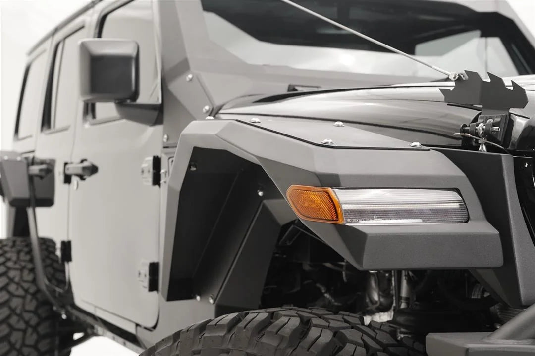 Close-up of Fab Fours front fender flare with LED turn signal on the passenger side of a gray Jeep Wrangler JL
