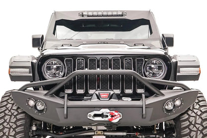 Fab Fours front fender flares with LED turn signals on a lifted black Jeep Wrangler JL, front view, with Fab Fours winch bumper and Warn winch