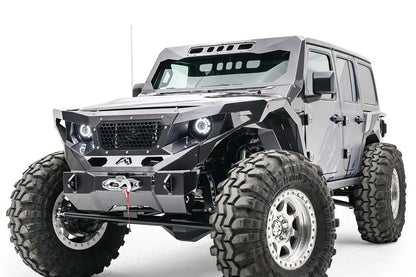 Fab Fours ViCowl on a lifted gray four-door Jeep Wrangler JL, front driver-side view, with the steel windshield cowl, matching fender armor, front bumper and winch