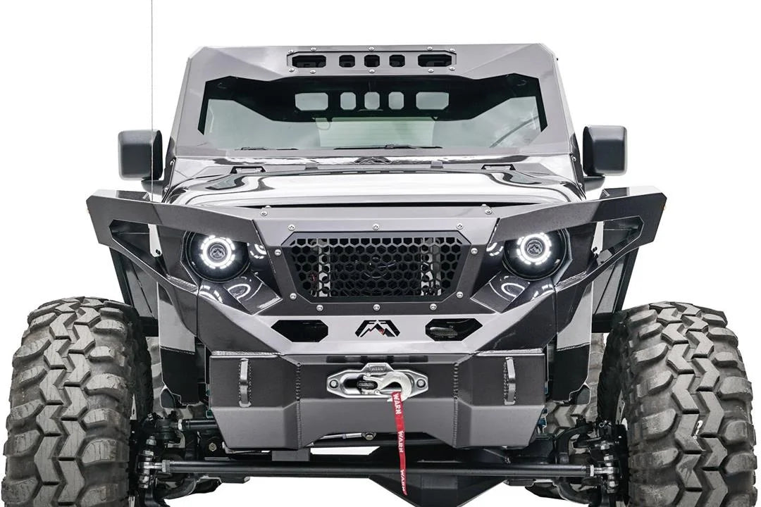 Fab Fours ViCowl on a lifted gray Jeep Wrangler JL, front view, showing the steel windshield cowl with slotted roof visor above a matching Fab Fours grille guard, halo headlights and winch bumper