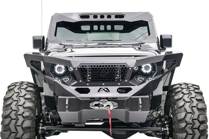 Fab Fours ViCowl on a lifted gray Jeep Wrangler JL, front view, showing the steel windshield cowl with slotted roof visor above a matching Fab Fours grille guard, halo headlights and winch bumper