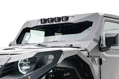 Fab Fours ViCowl light insert on a Jeep Wrangler JL, close-up from the driver side, showing four cube pod lights mounted across the top of the gray ViCowl windshield frame