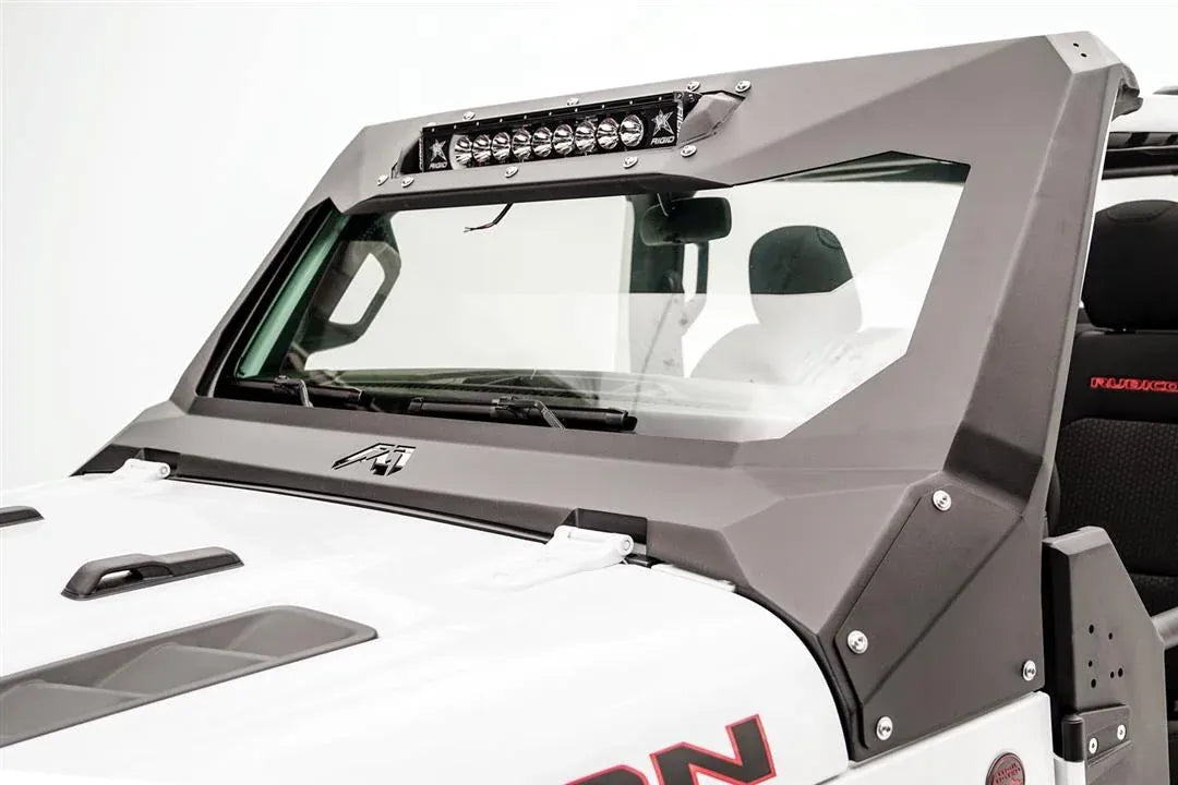 Close-up of the Fab Fours ViCowl light bar insert on a white Jeep Wrangler JL, driver side, showing the LED light bar bolted into the steel cowl above the windshield