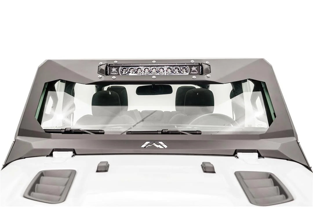 Fab Fours ViCowl light bar insert on a white Jeep Wrangler JL, front view, holding a single LED light bar across the top of the matte black steel windshield cowl