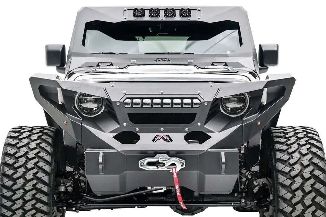 Fab Fours front fenders with amber marker lights on a lifted black Jeep Wrangler JL, front view, with Fab Fours winch bumper, Warn winch, and cowl light bar