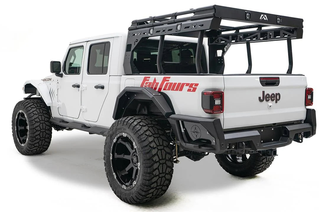 Fab Fours rear fender flare on a lifted white Jeep Gladiator Rubicon with overland bed rack and red Fab Fours graphics, driver-side rear three-quarter view