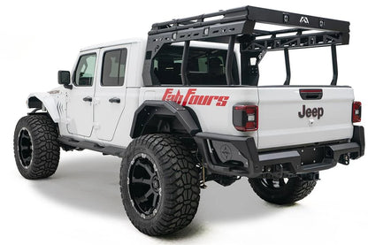 Fab Fours rear fender flare on a lifted white Jeep Gladiator Rubicon with overland bed rack and red Fab Fours graphics, driver-side rear three-quarter view