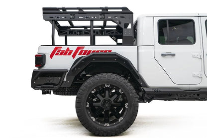 Fab Fours rear fender flare on a lifted white Jeep Gladiator with overland bed rack and red Fab Fours graphics, passenger-side view of the rear wheel