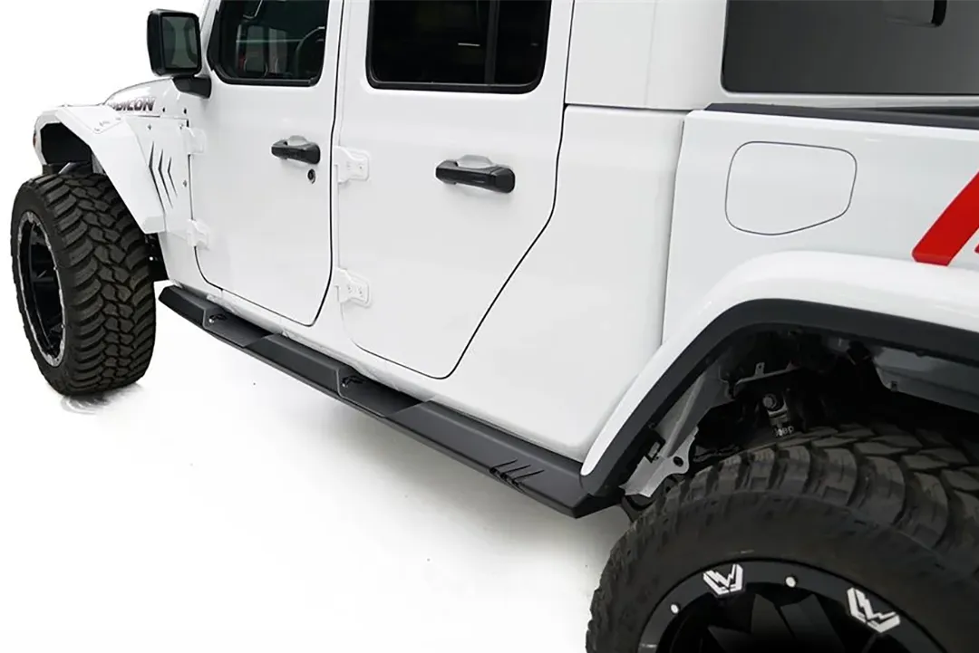 Fab Fours rock slider on a white Jeep Gladiator Rubicon, rear driver-side view