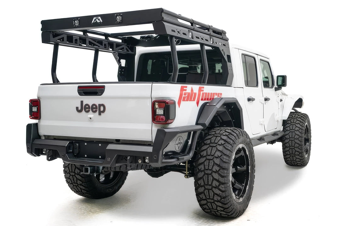 Fab Fours Overland Bed Rack on a white Jeep Gladiator, rear passenger-side view, showing the black platform with cube lights and Fab Fours logo, tubular uprights and slotted side rails over the bed