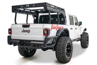 Fab Fours Overland Bed Rack on a white Jeep Gladiator, rear passenger-side view, showing the black platform with cube lights and Fab Fours logo, tubular uprights and slotted side rails over the bed