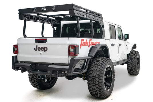 Fab Fours Overland Bed Rack on a white Jeep Gladiator, rear passenger-side view, showing the black platform with cube lights and Fab Fours logo, tubular uprights and slotted side rails over the bed