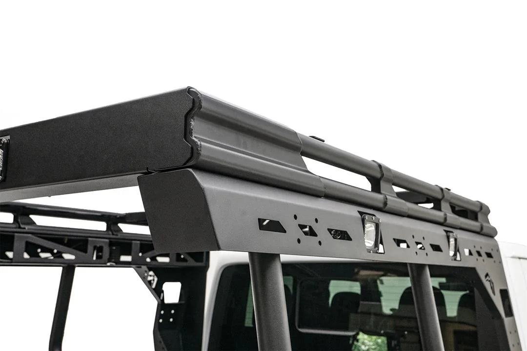 Close-up of the Fab Fours Overland Bed Rack passenger-side rail on a Jeep Gladiator, showing the slotted mounting panel, integrated cube lights and tubular uprights