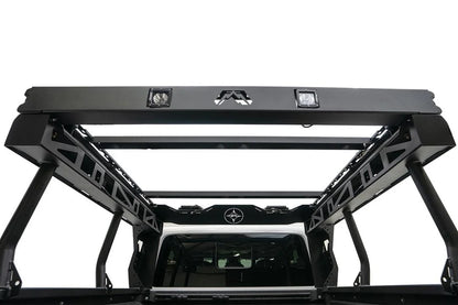 Fab Fours Overland Bed Rack on a Jeep Gladiator, rear view from the bed, showing the logo-cut rear bar with two cube lights, cross-members and cross-braced side frames