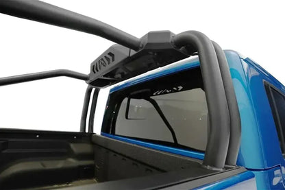 Close-up of Fab Fours sport rack tubes and center panel behind the cab of a blue Jeep Gladiator