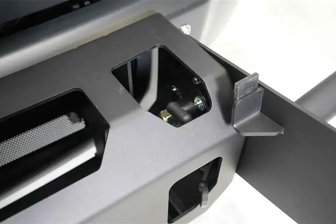 Fab Fours winch mount, close-up detail, showing the black powder-coated steel plate, mounting cutout and bracket hardware