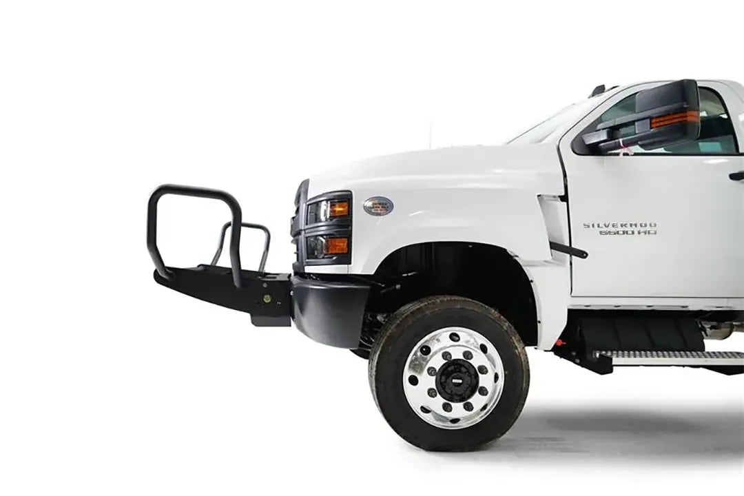 Fab Fours winch mount on a white Chevrolet Silverado 4500 chassis cab, driver-side profile view, showing the tube guard projection and mounting depth