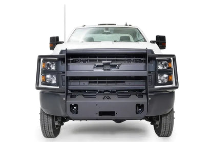 Fab Fours winch mount with full guard on a white Chevrolet Silverado 4500, straight-on front view, showing the full grille guard, headlight hoops and winch tray