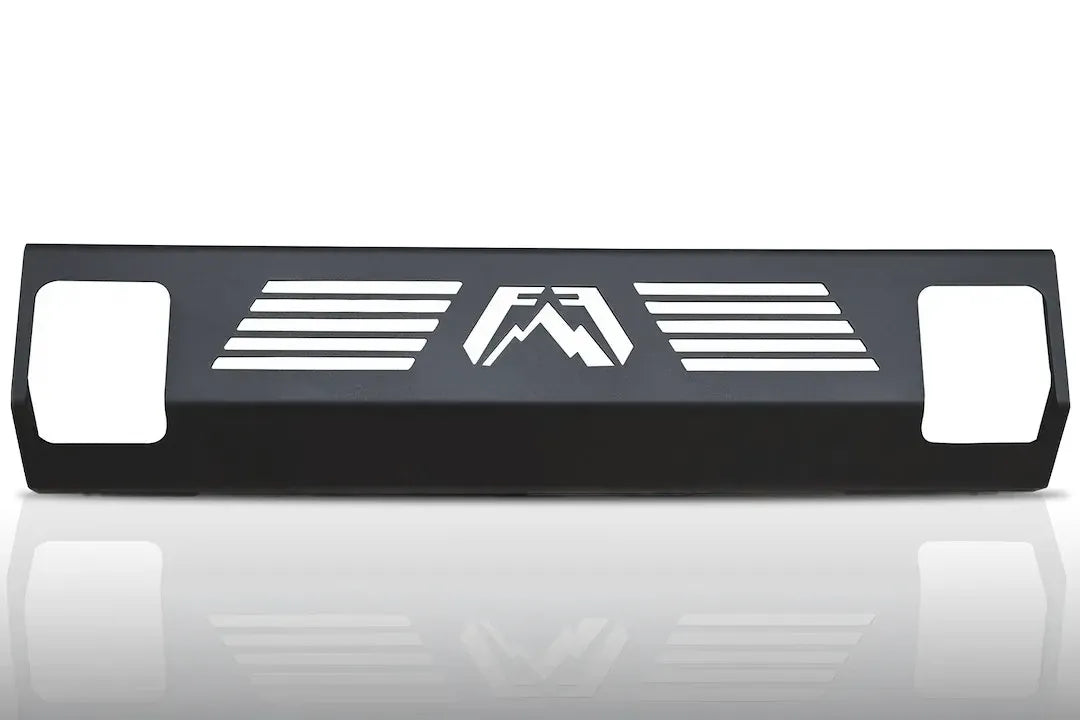 Fab Fours steel hi-flow lower guard for KGAIR-compatible bumpers, matte black steel panel with horizontal vent slots, center Fab Fours logo cutout and end openings on a white background