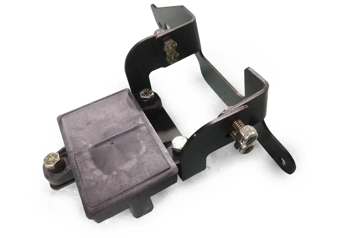 Fab Fours adaptive cruise control relocation bracket in black powder coat, angled view, showing the bracket with the cruise control sensor mounted and bolt hardware
