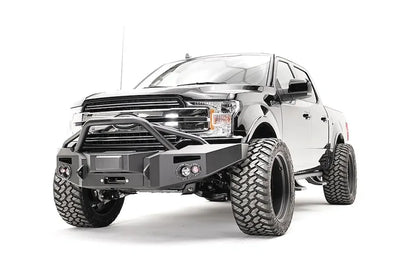 Fab Fours adaptive cruise control relocation bracket in a Fab Fours Premium winch front bumper with pre-runner guard on a lifted black Ford F-150, driver-side front three-quarter view