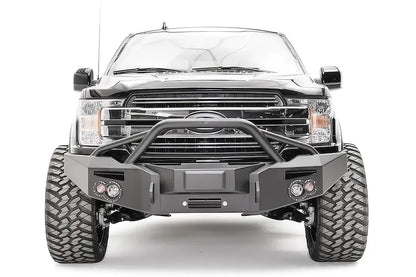 Fab Fours adaptive cruise control relocation bracket centered in a Fab Fours Premium winch front bumper with pre-runner guard on a black Ford F-150, front view