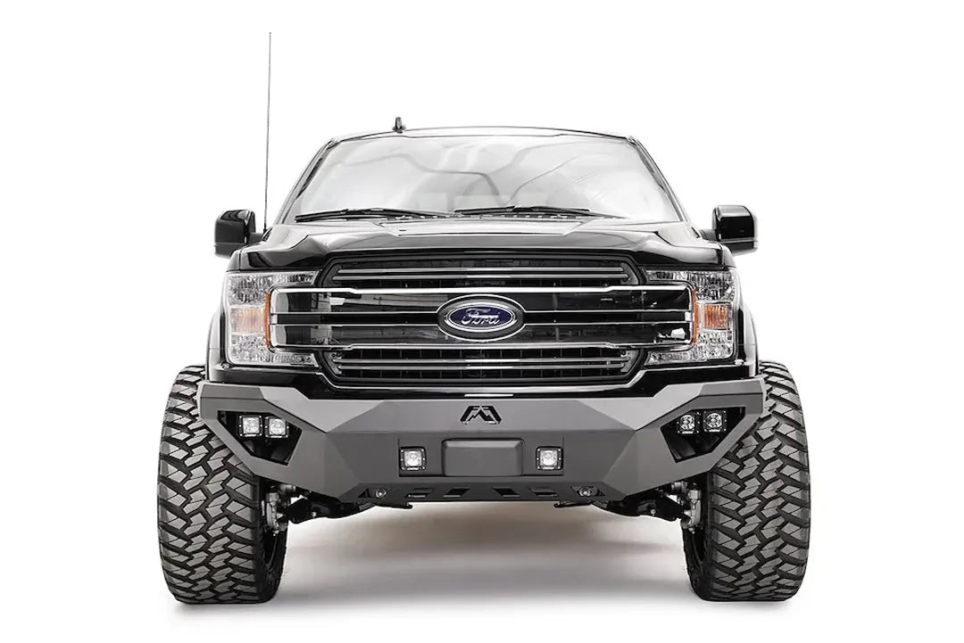 Fab Fours front bumper with adaptive cruise control relocation bracket on a lifted black Ford F-150, front view